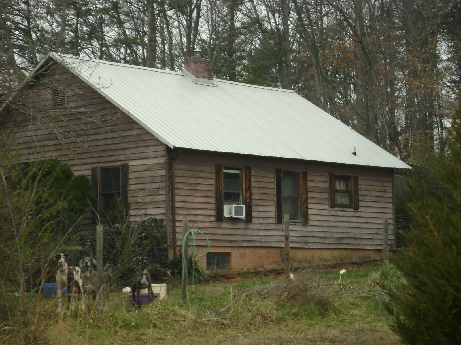 White metal roof on an old wood sided farmhouse, from a Metal Roof Installation job in Christiansburg